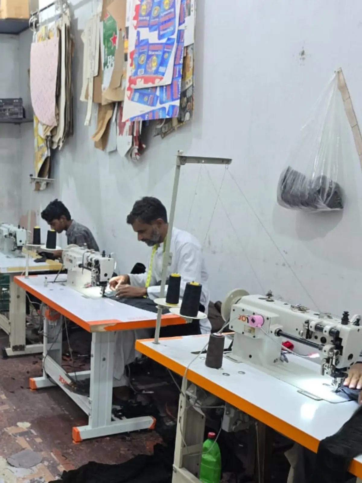 Prince Textile artisans working at sewing stations in the Chawinda workshop